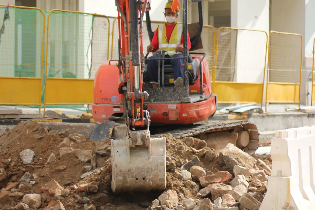 Illustrative mini excavator doing compact dig work
