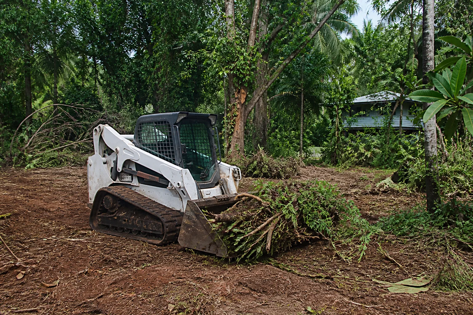 Illustrative compact Bobcat skid steer used for site cleanup and material handling